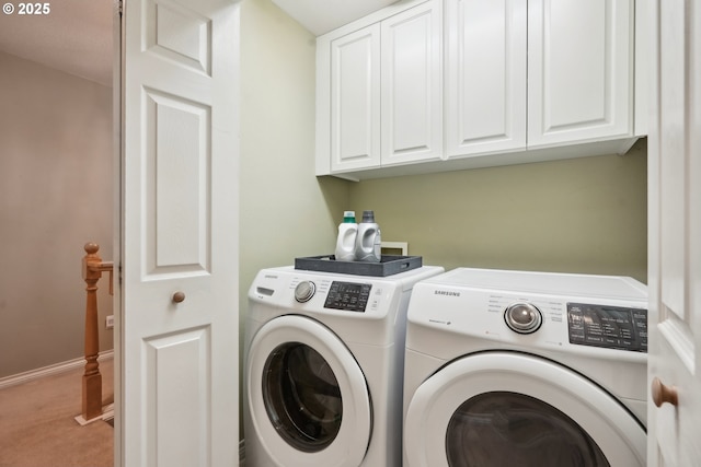 laundry area with baseboards, cabinet space, and washing machine and clothes dryer