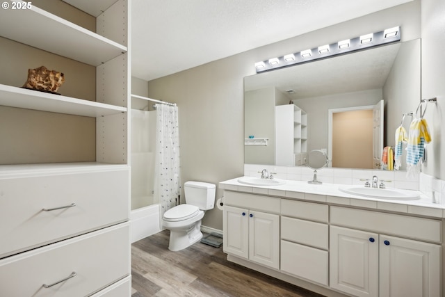 full bathroom with wood finished floors, toilet, double vanity, and shower / bath combination with curtain