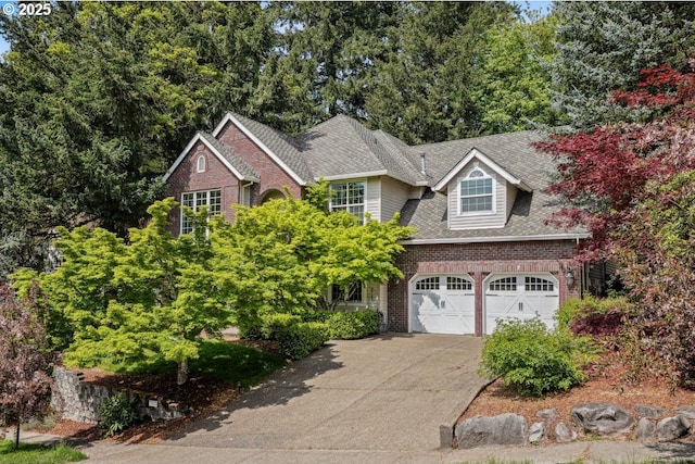 traditional-style house featuring brick siding, driveway, a garage, and a shingled roof