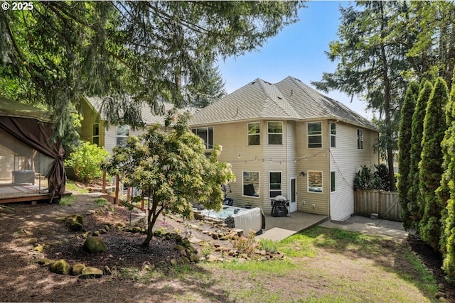 back of property featuring a patio area and fence