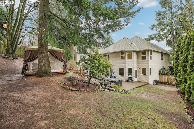 back of property with a patio and fence