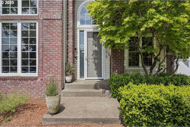 doorway to property with brick siding