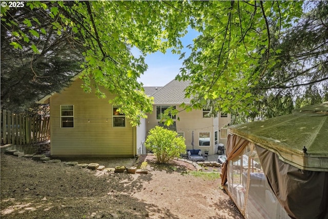 rear view of house with fence