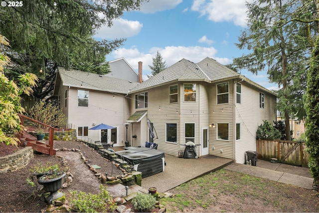 back of house with a patio, a hot tub, and fence