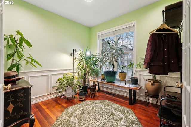 interior space featuring a wainscoted wall and wood finished floors