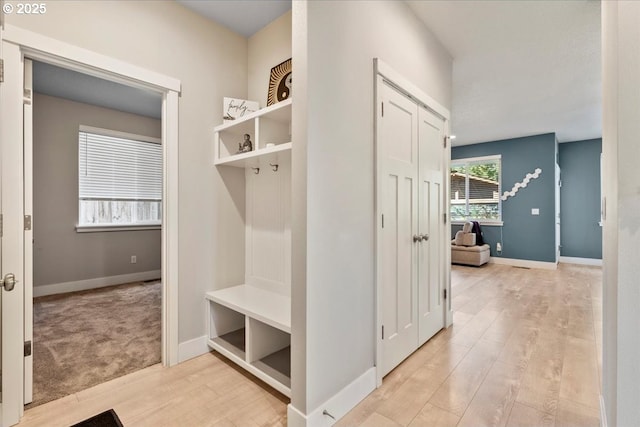 mudroom with light hardwood / wood-style floors