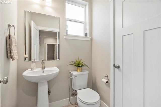 bathroom featuring toilet and sink