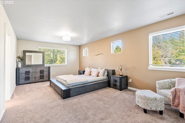 carpeted bedroom featuring a textured ceiling