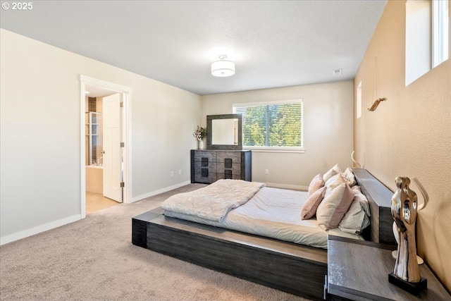 bedroom featuring light colored carpet and connected bathroom