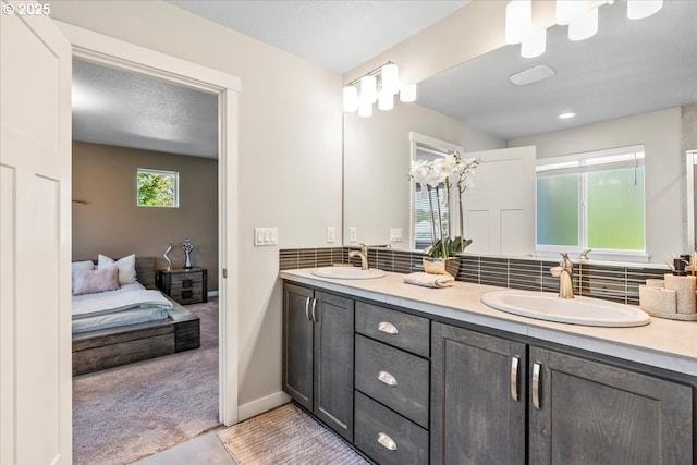 bathroom featuring decorative backsplash, vanity, and tile patterned floors