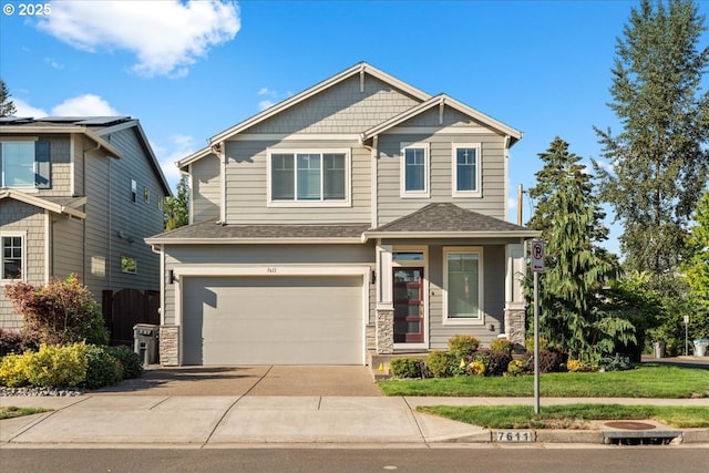 craftsman-style home featuring a front lawn and a garage