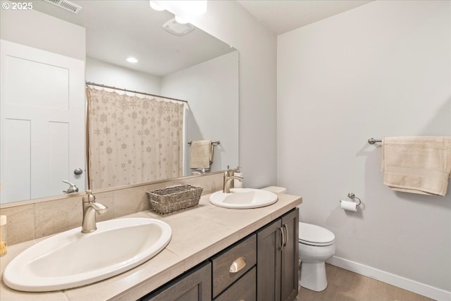 bathroom featuring toilet, vanity, hardwood / wood-style flooring, and a shower with curtain