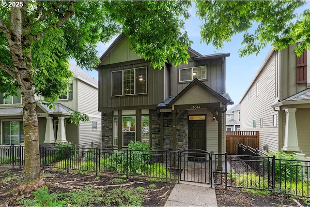 16044 SW Langer Dr, Sherwood, OR 97140 - craftsman inspired home with board and batten siding, a fenced front yard, stone siding, and a gate