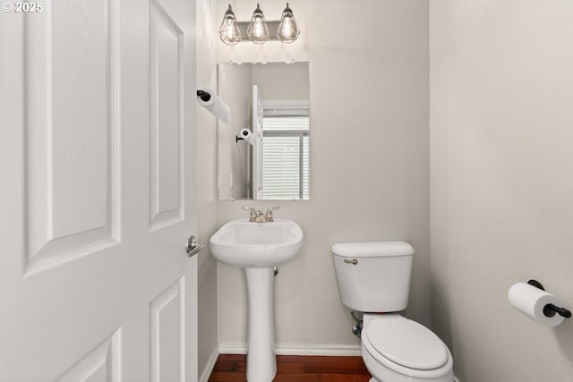16044 SW Langer Dr, Sherwood, OR 97140 - bathroom with toilet, baseboards, a sink, and wood finished floors