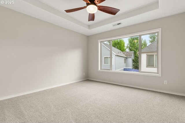 16044 SW Langer Dr, Sherwood, OR 97140 - carpeted spare room with a raised ceiling, baseboards, and ceiling fan