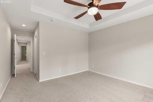 16044 SW Langer Dr, Sherwood, OR 97140 - spare room with light carpet, a ceiling fan, baseboards, recessed lighting, and a raised ceiling