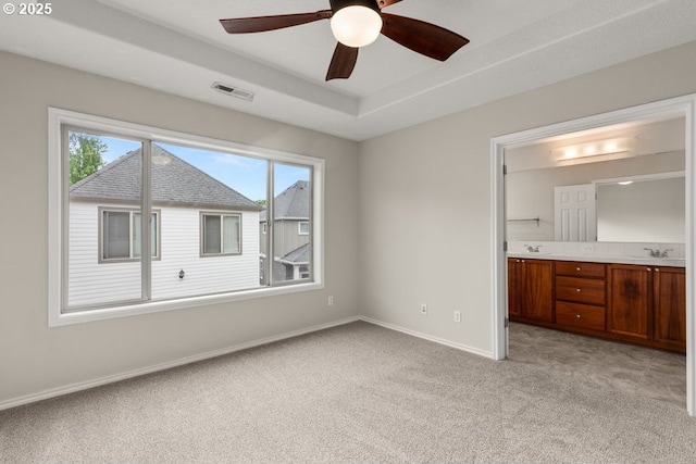16044 SW Langer Dr, Sherwood, OR 97140 - unfurnished bedroom with light colored carpet, a sink, baseboards, and connected bathroom