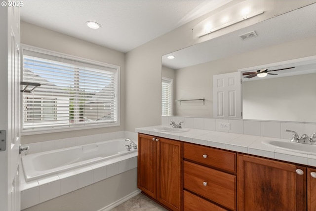 16044 SW Langer Dr, Sherwood, OR 97140 - full bathroom with double vanity, a bath, ceiling fan, and recessed lighting
