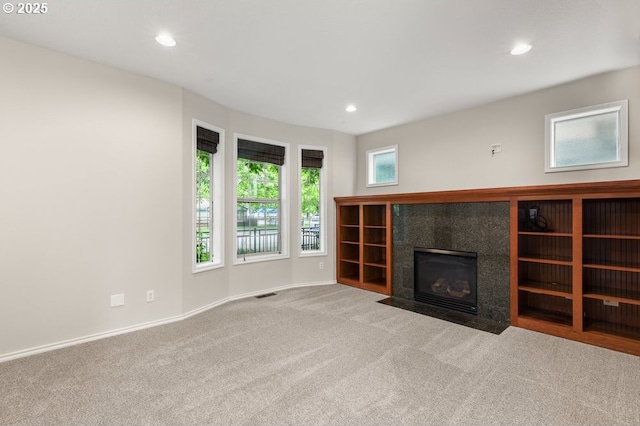 16044 SW Langer Dr, Sherwood, OR 97140 - unfurnished living room with carpet floors, recessed lighting, a tile fireplace, and baseboards