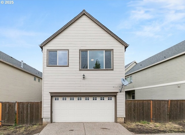 16044 SW Langer Dr, Sherwood, OR 97140 - rear view of house featuring an attached garage, concrete driveway, and fence