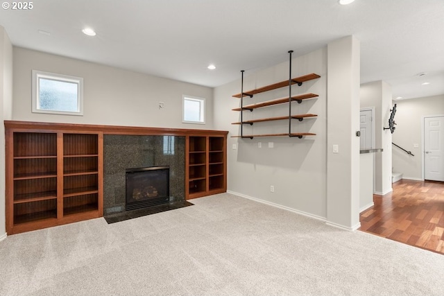 16044 SW Langer Dr, Sherwood, OR 97140 - unfurnished living room featuring carpet floors, baseboards, plenty of natural light, recessed lighting, and a fireplace