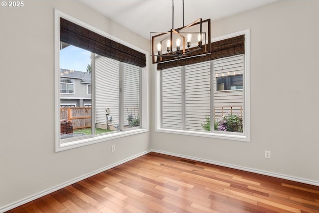 16044 SW Langer Dr, Sherwood, OR 97140 - unfurnished dining area with a chandelier, wood finished floors, and baseboards
