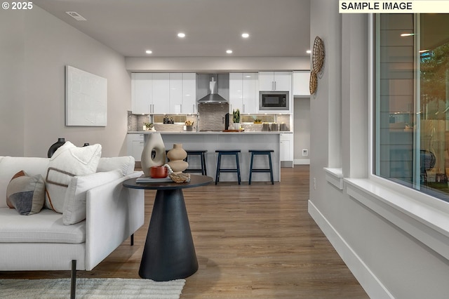 living room with recessed lighting, visible vents, baseboards, and dark wood finished floors