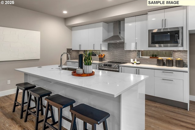 kitchen with dark wood-style floors, white cabinetry, stainless steel electric range oven, wall chimney exhaust hood, and built in microwave