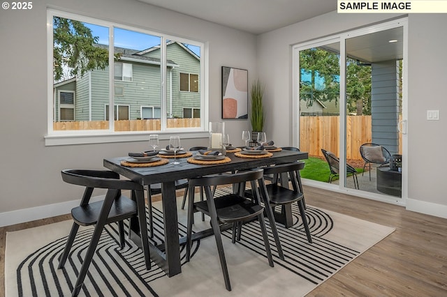 dining area with wood finished floors and baseboards