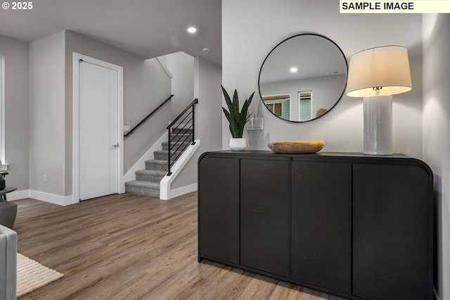 interior space featuring stairway, recessed lighting, baseboards, and wood finished floors