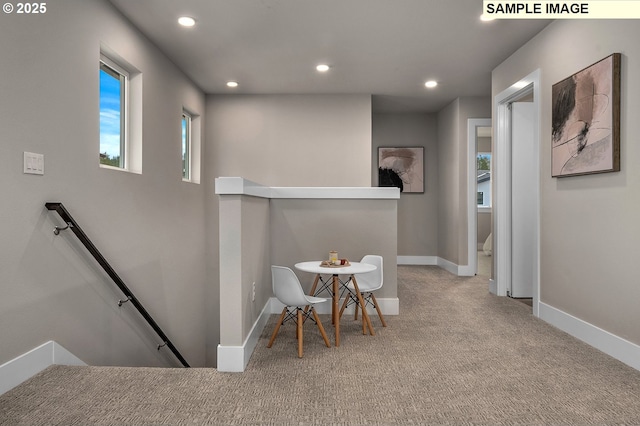 hall featuring recessed lighting, baseboards, an upstairs landing, and carpet