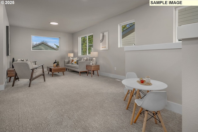 living area with recessed lighting, baseboards, and carpet flooring