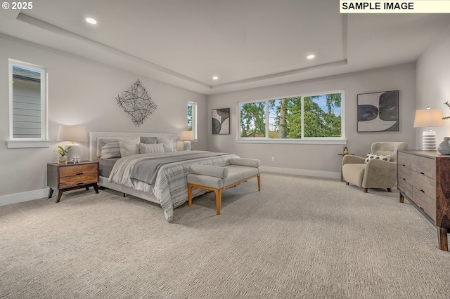 bedroom featuring a raised ceiling, recessed lighting, light colored carpet, and baseboards