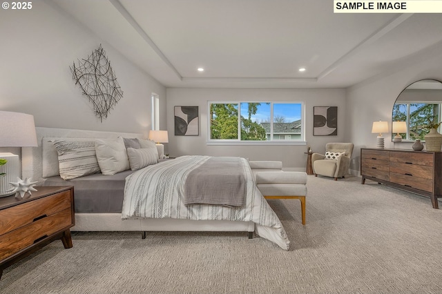 bedroom featuring a raised ceiling, recessed lighting, and carpet