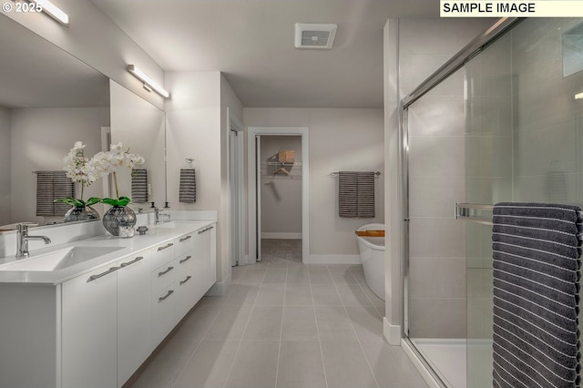 bathroom with a shower stall, a soaking tub, visible vents, and a sink