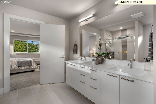 full bathroom with tile patterned flooring, a stall shower, double vanity, and a sink