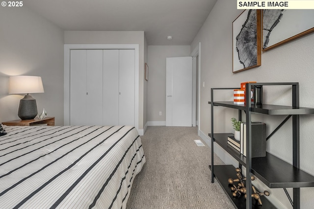 bedroom with carpet, a closet, and baseboards