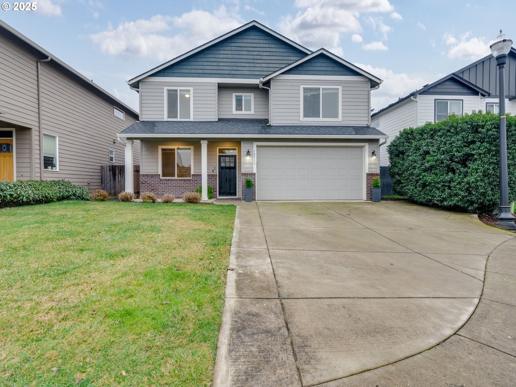 view of front of home featuring a front yard and a garage