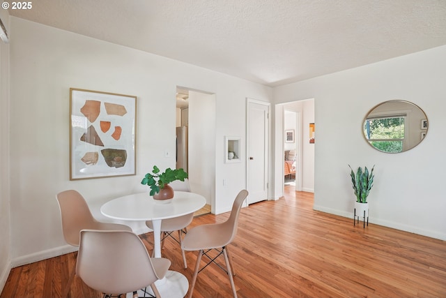 4433 NE 65th Ave, Portland, OR 97218 - dining room featuring light wood-type flooring and a textured ceiling