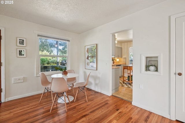 4433 NE 65th Ave, Portland, OR 97218 - dining space with light wood finished floors, healthy amount of natural light, and a textured ceiling