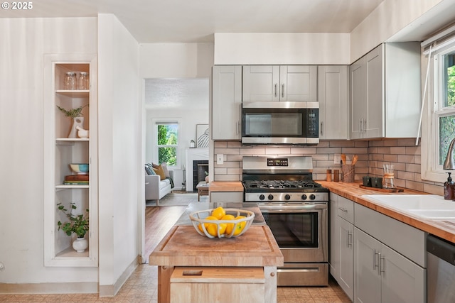 4433 NE 65th Ave, Portland, OR 97218 - kitchen featuring appliances with stainless steel finishes, healthy amount of natural light, and gray cabinetry