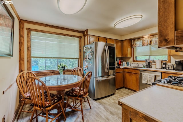 1445 NE 17th St, Gresham, OR 97030 - kitchen with appliances with stainless steel finishes, brown cabinets, light wood-type flooring, and light countertops