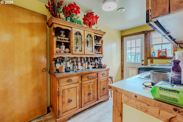 1445 NE 17th St, Gresham, OR 97030 - kitchen featuring light wood-style floors, brown cabinetry, glass insert cabinets, and open shelves