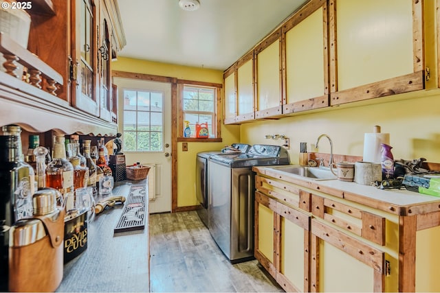 1445 NE 17th St, Gresham, OR 97030 - washroom with light wood-type flooring, independent washer and dryer, and cabinet space