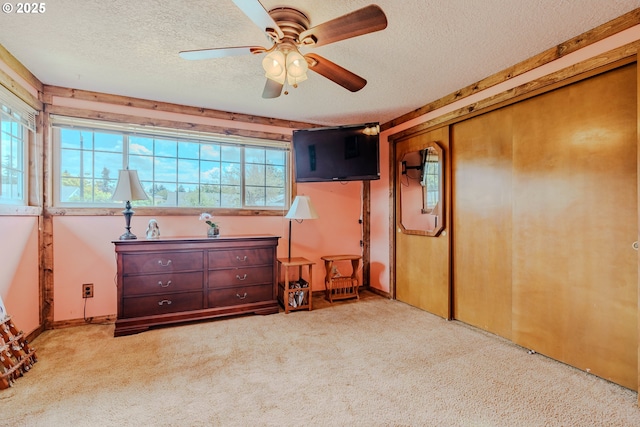1445 NE 17th St, Gresham, OR 97030 - unfurnished bedroom featuring a textured ceiling, carpet flooring, multiple windows, ceiling fan, and a closet