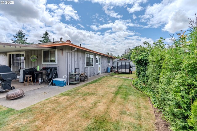 1445 NE 17th St, Gresham, OR 97030 - back of property featuring a lawn, a patio, and board and batten siding
