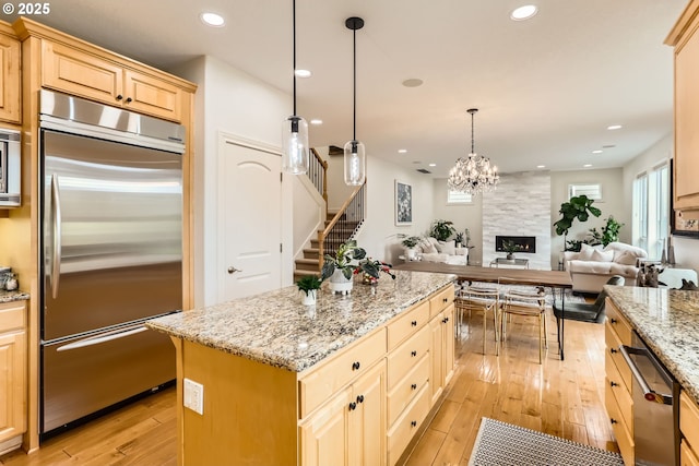 18350 SW Florendo Ln, Beaverton, OR 97007 - kitchen featuring open floor plan, light wood-style floors, appliances with stainless steel finishes, and light brown cabinets
