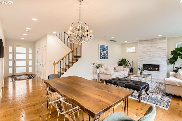 18350 SW Florendo Ln, Beaverton, OR 97007 - dining area with visible vents, a tiled fireplace, light wood-style floors, recessed lighting, and stairway