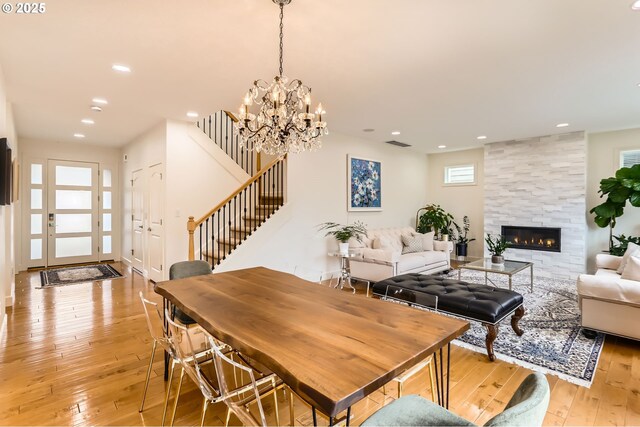 18350 SW Florendo Ln, Beaverton, OR 97007 - dining room featuring light wood-style flooring, visible vents, recessed lighting, stairway, and a tile fireplace