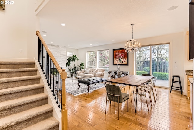 18350 SW Florendo Ln, Beaverton, OR 97007 - dining area featuring light wood-style flooring, stairway, an inviting chandelier, and a healthy amount of sunlight